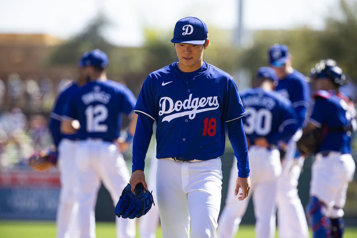 Los Angeles Dodgers pitcher Yoshinobu Yamamoto reacts after being pulled from the game against the Seattle Mariners during a spring training game at Camelback Ranch-Glendale