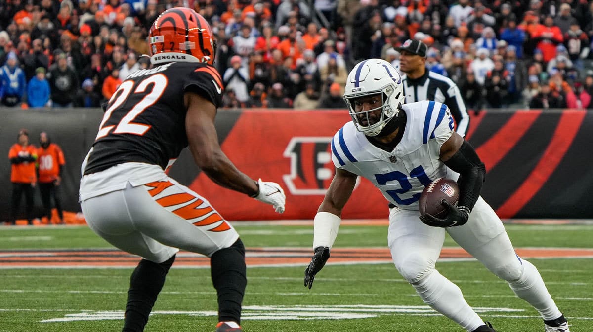 Colts running back Zack Moss (21) goes up against Bengals corner back Chidobe Awuzie (22) during the Bengals vs. Colts game at Paycor Stadium on Sunday December 10, 2023. The game was tied 14-14 at halftime.