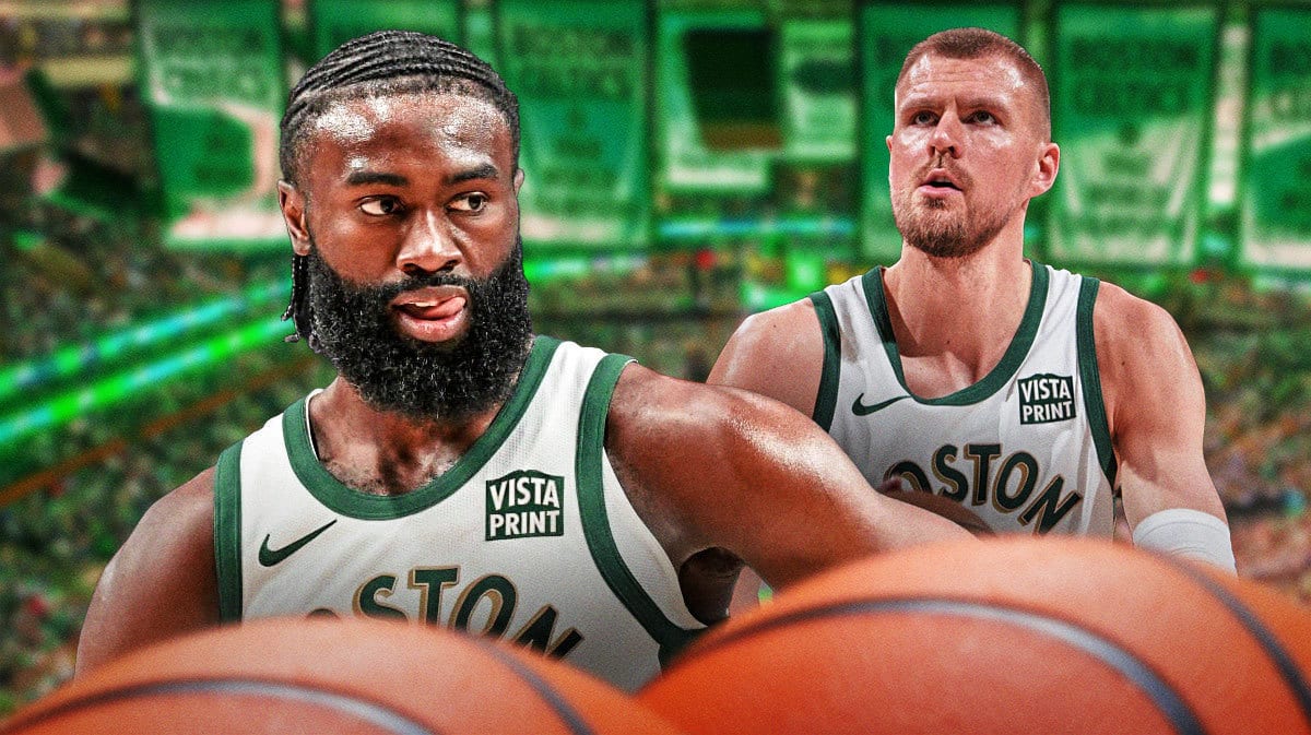 Jaylen Brown, Kristaps Porzingis both sitting down on an NBA sideline looking serious.