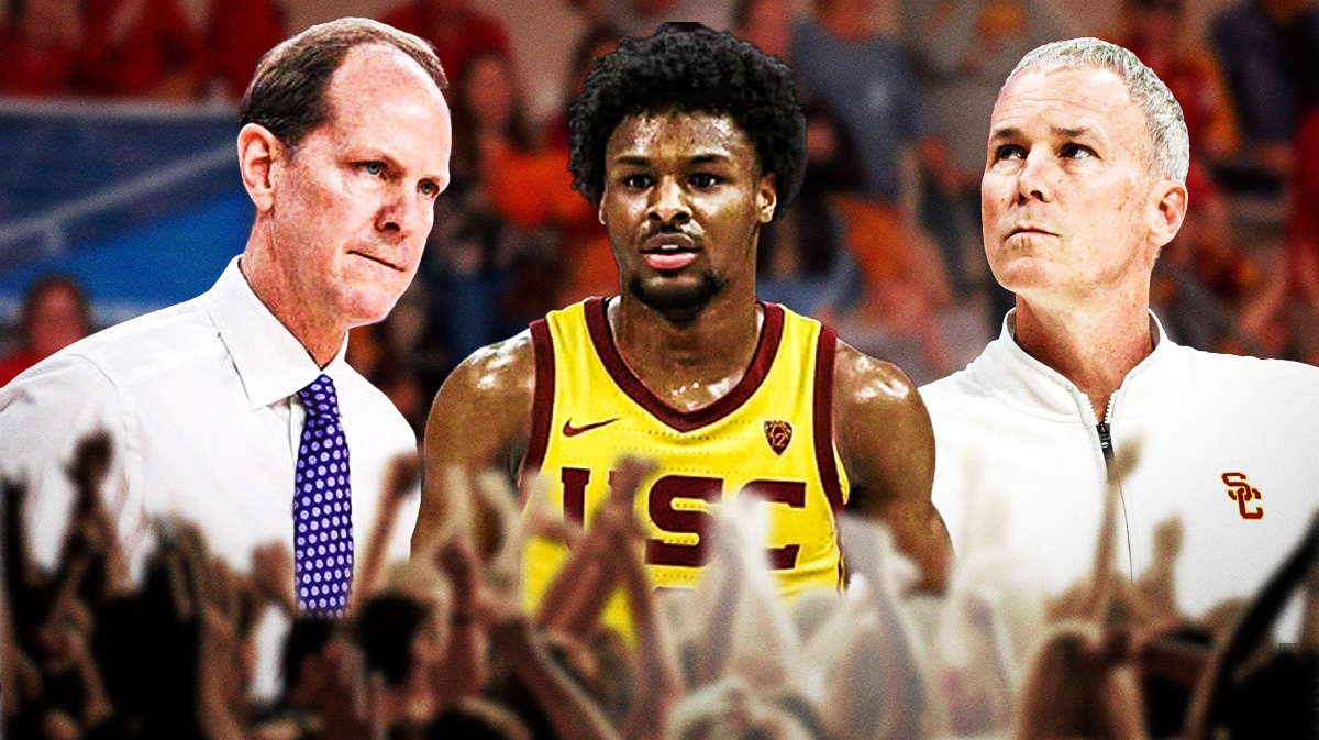 USC basketball coach Andy Enfield and Washington coach Mike Hopkins looking at Bronny James.