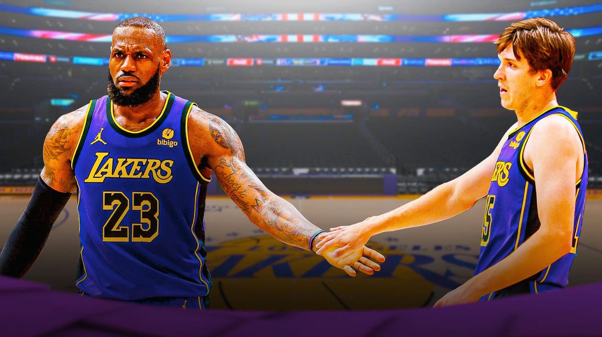 Lebron James and Austin Reaves side by side bumping fists