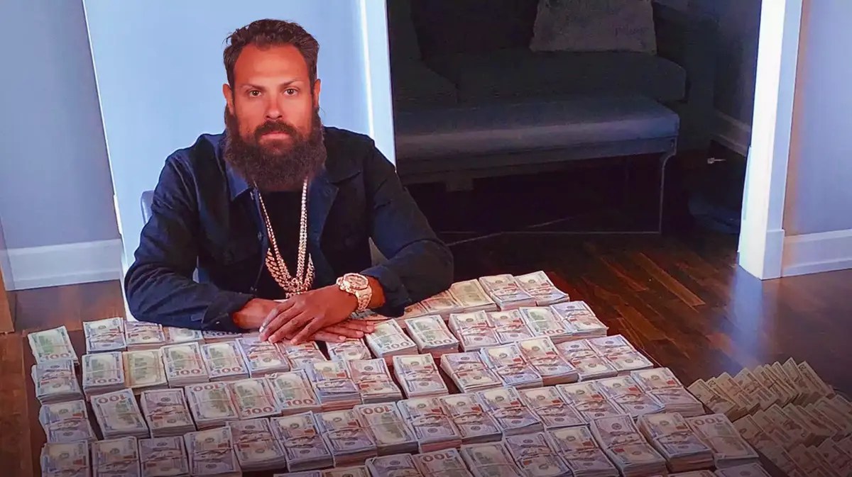 Zach Bogosian (Wild) as Floyd Mayweather with money