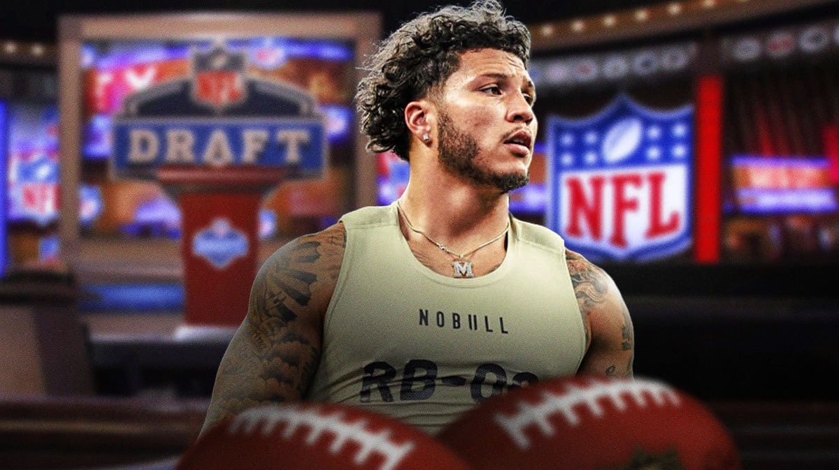 Michigan football player Blake Corum smiling with an NFL Draft background