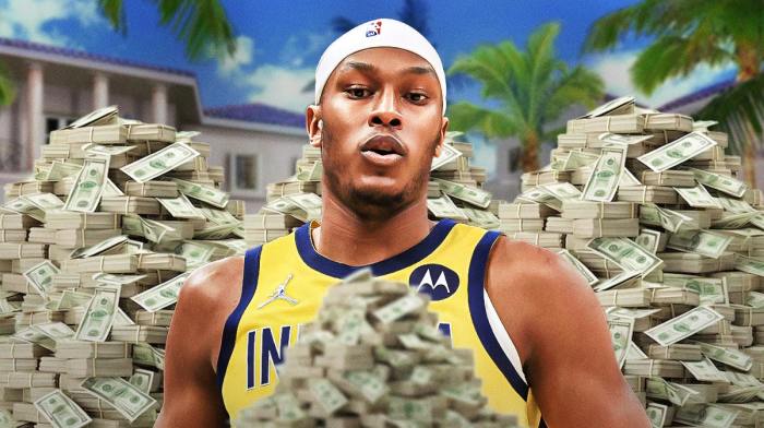 Myles Turner surrounded by piles of cash.