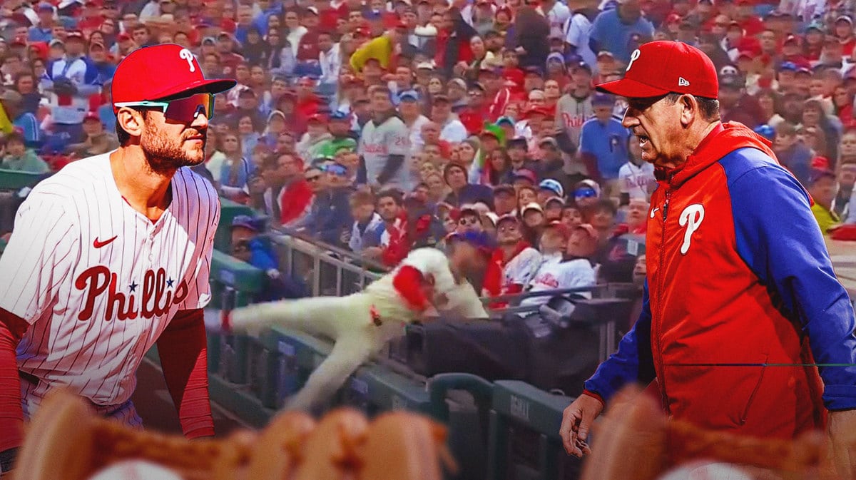Phillies Bryce Harper falls over railing while Rob Thomson and Trea Turner watch