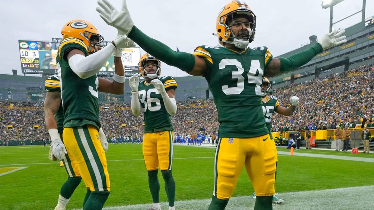 Green Bay Packers defenders including Green Bay Packers safety Jonathan Owens (34) celebrate Green Bay Packers safety Anthony Johnson Jr. (36) interception 