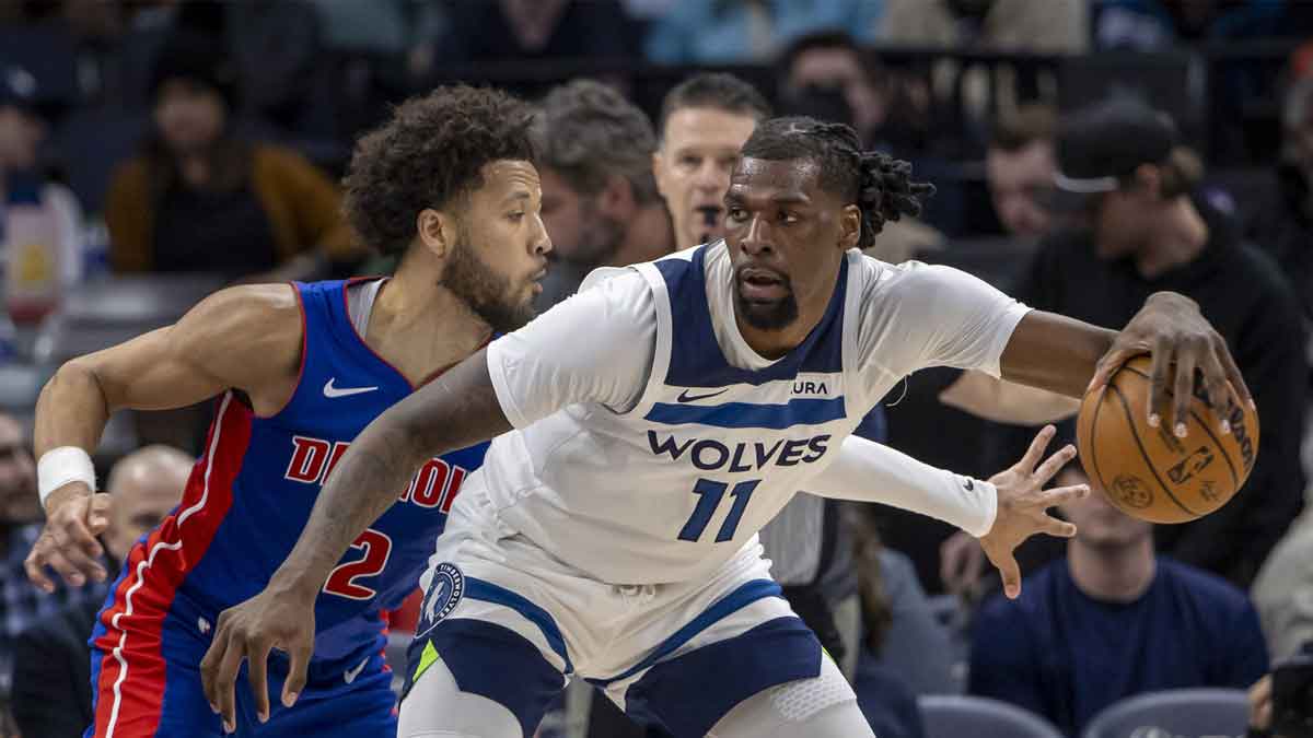 Minnesota Timberwolves center Naz Reid (11) backs towards the basket and keeps the ball away from Detroit Pistons guard Cade Cunningham (2) in the second half at Target Center
