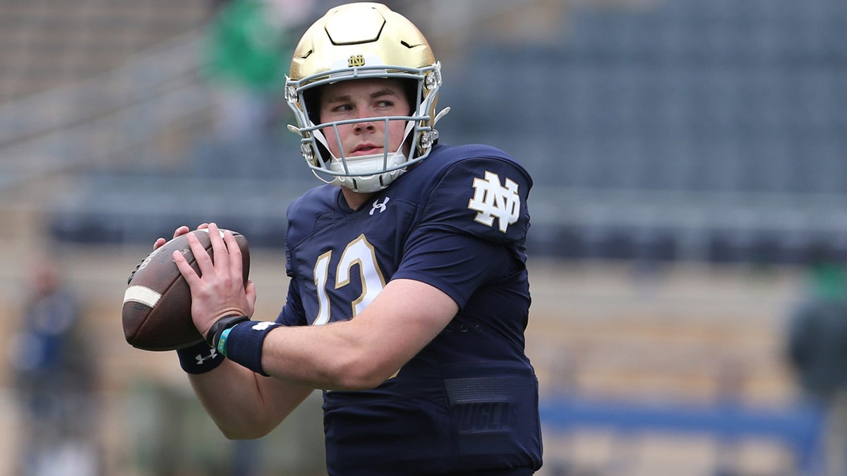 Notre Dame quarterback Riley Leonard (13) who is hurt, dresses and throws some pre-game passes with fellow quarterbacks