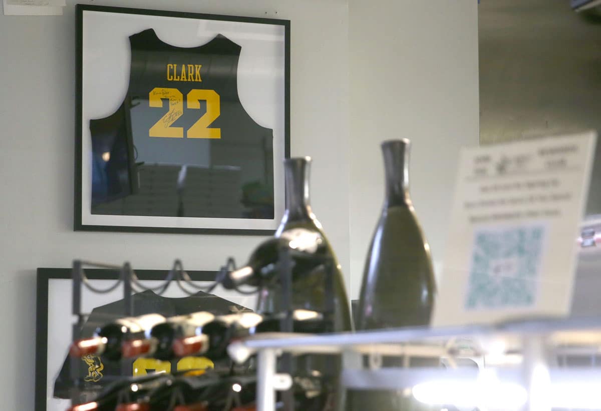 A signed Caitlin Clark jersey hangs on the wall at Graze Gourmet To Go in Iowa City, Iowa.