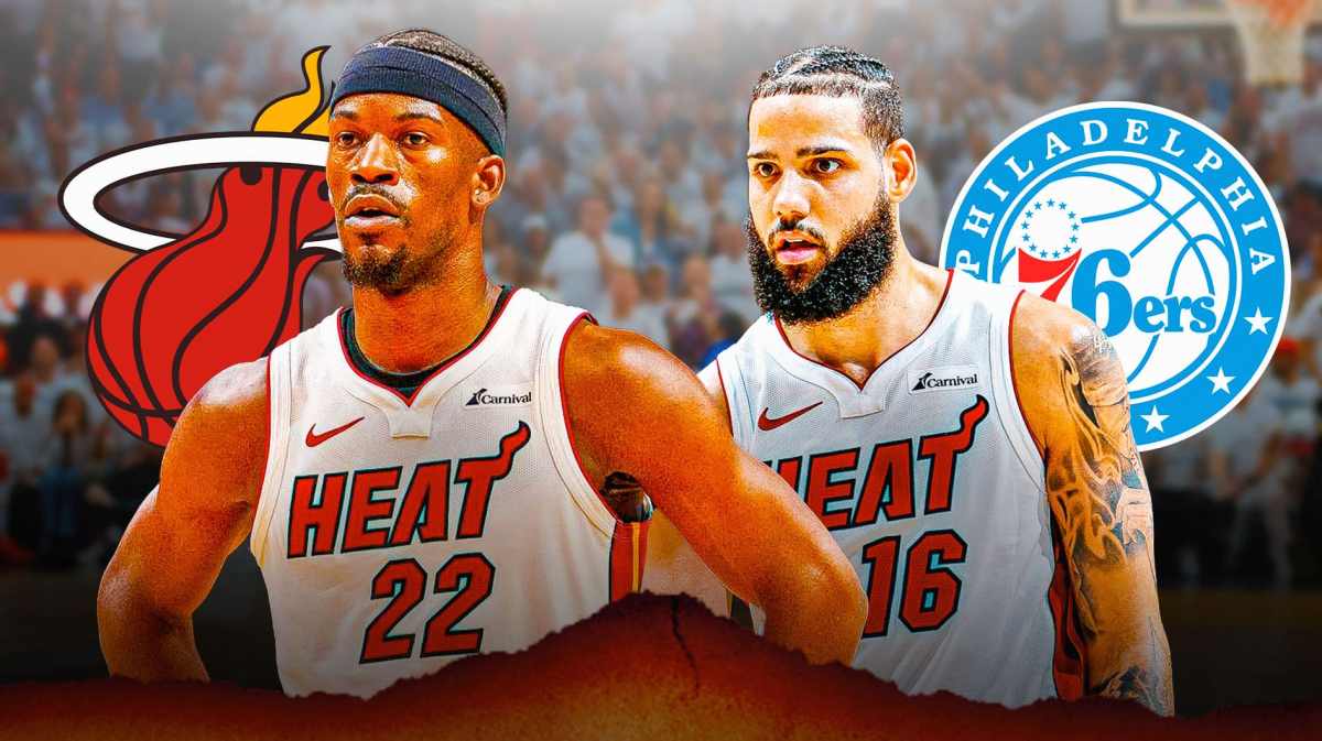 Heat's Jimmy Butler stands next to Caleb Martin and 76ers logo, NBA Play-In fans in background