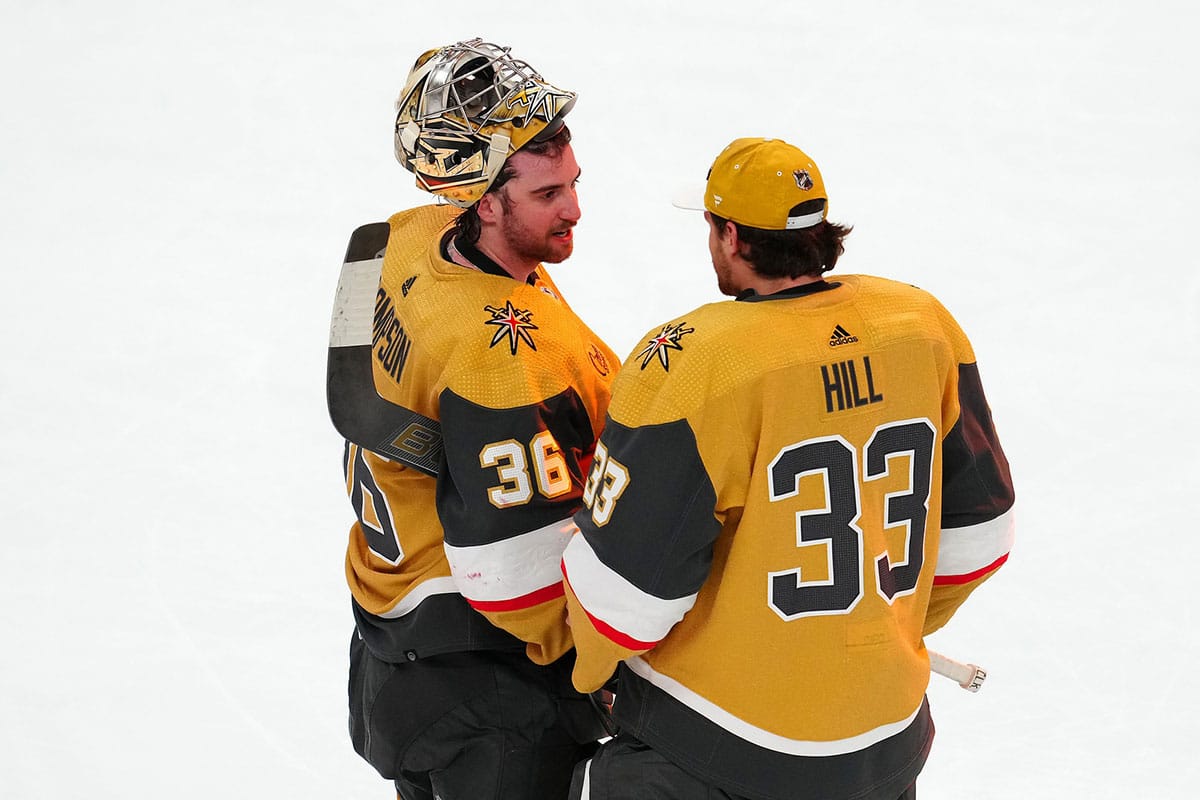 Vegas Golden Knights goaltender Logan Thompson (36) talks with goaltender Adin Hill (33) after the Golden Knights defeated the Chicago Blackhawks 3-1 at T-Mobile Arena.