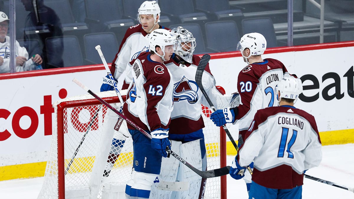 Colorado Avalanche goalie Alexander Georgiev (40) is congratulated by his teammates on the win against the Winnipeg Jets at the end of the third period in game two of the first round of the 2024 Stanley Cup Playoffs at Canada Life Centre. 