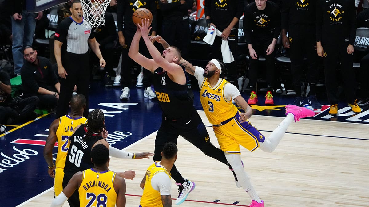 Apr 22, 2024; Denver, Colorado, USA; Los Angeles Lakers forward Anthony Davis (3) fouls Denver Nuggets center Nikola Jokic (15)) in the fourth quarter during game two during the 2024 NBA playoffs at Ball Arena. Mandatory Credit: Ron Chenoy-USA TODAY Sports