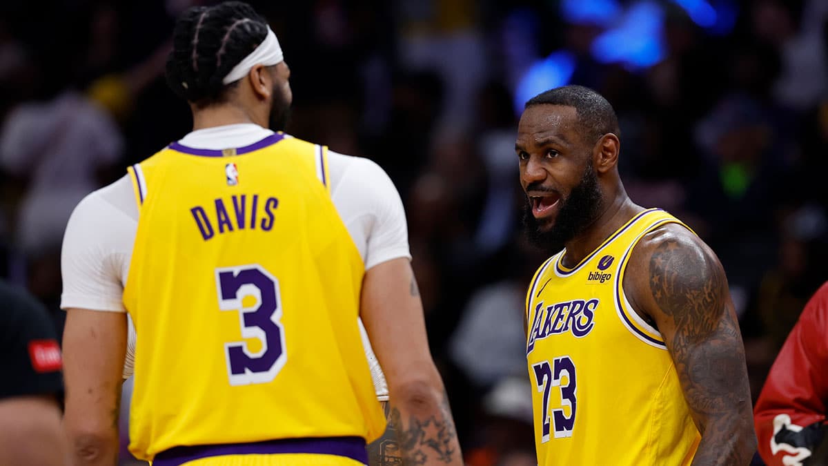 Los Angeles Lakers forward LeBron James (23) talks with Lakers forward Anthony Davis (3) during a timeout against the Washington Wizards in the second half at Capital One Arena. 