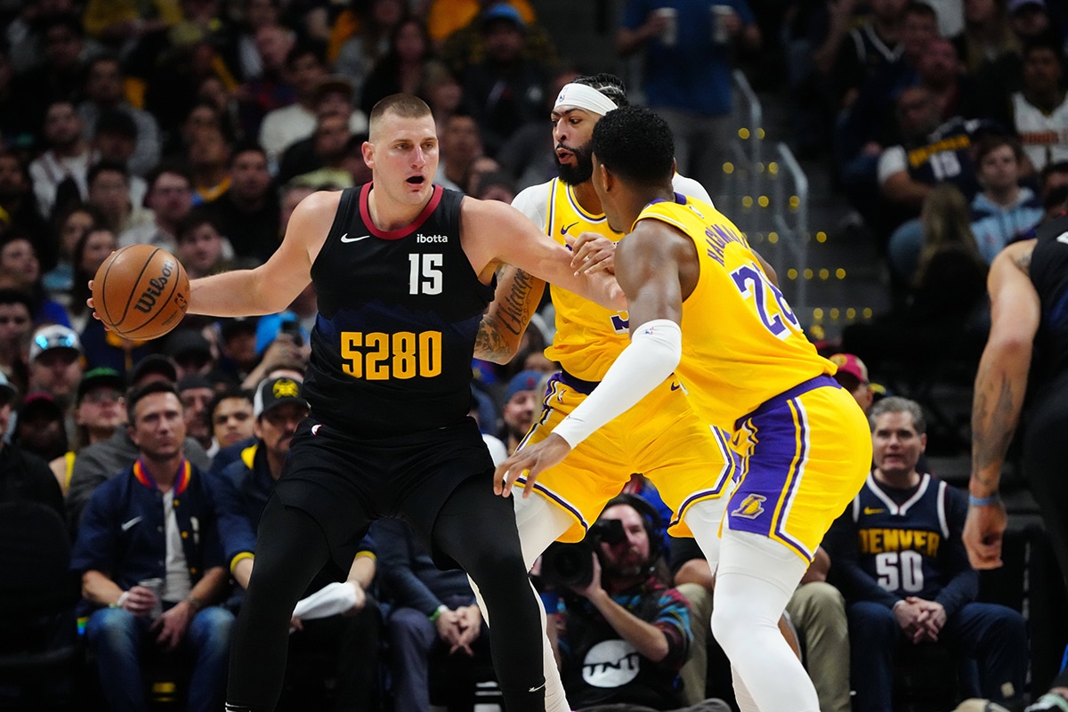 Los Angeles Lakers forward Anthony Davis (3) and Los Angeles Lakers forward Rui Hachimura (28) defend Denver Nuggets center Nikola Jokic (15) in the first half during game two during the 2024 NBA playoffs at Ball Arena