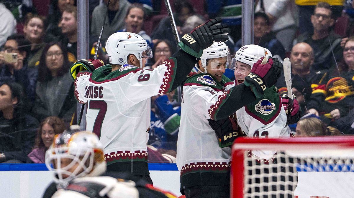 Arizona Coyotes forward Lawson Crouse (67) and forward Dylan Guenther (11) and forward Logan Cooley (92) celebrate Cooley’s game winning overtime goal against the Vancouver Canucks at Rogers Arena. Arizona won 4-3 in overtime.