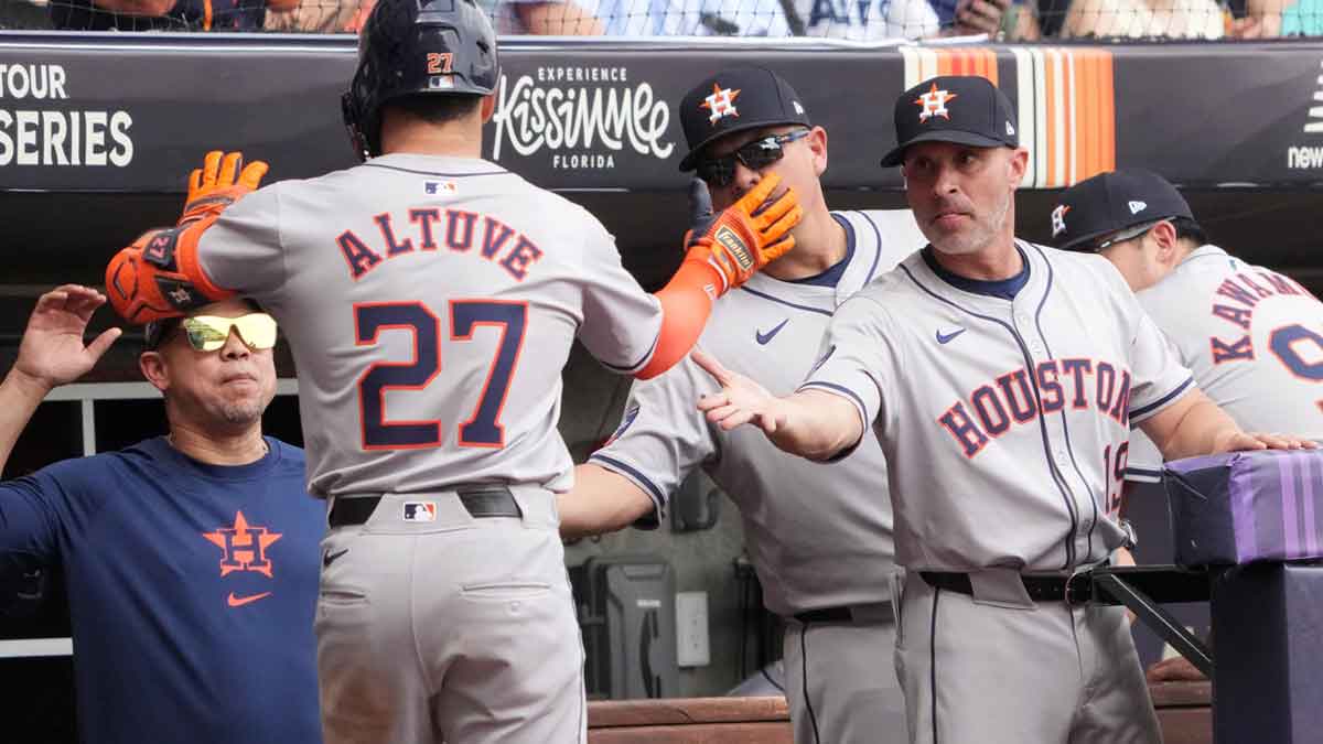 Houston Astros second baseman Jose Altuve (27) is congratulated by manager Joe Espada (19) after hitting a home run in the third inning against the Colorado Rockies during the MLB World Tour Mexico City Series game at Estadio Alfredo Harp Helu. 