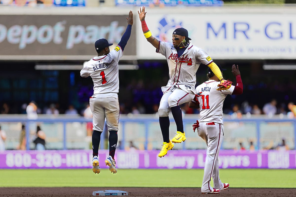 Atlanta Braves right fielder Ronald Acuna Jr. (13) celebrates with Atlanta Braves second baseman Ozzie Albies (1) after the game against the Miami Marlins at loanDepot Park.