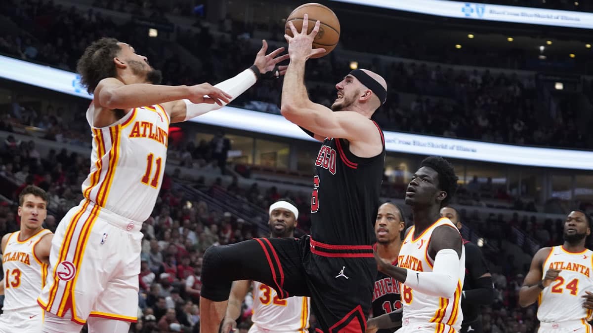 Apr 17, 2024; Chicago, Illinois, USA; Atlanta Hawks guard Trae Young (11) defends Chicago Bulls guard Alex Caruso (6) during the first quarter during a play-in game of the 2024 NBA playoffs at United Center. Mandatory Credit: David Banks-USA TODAY Sports