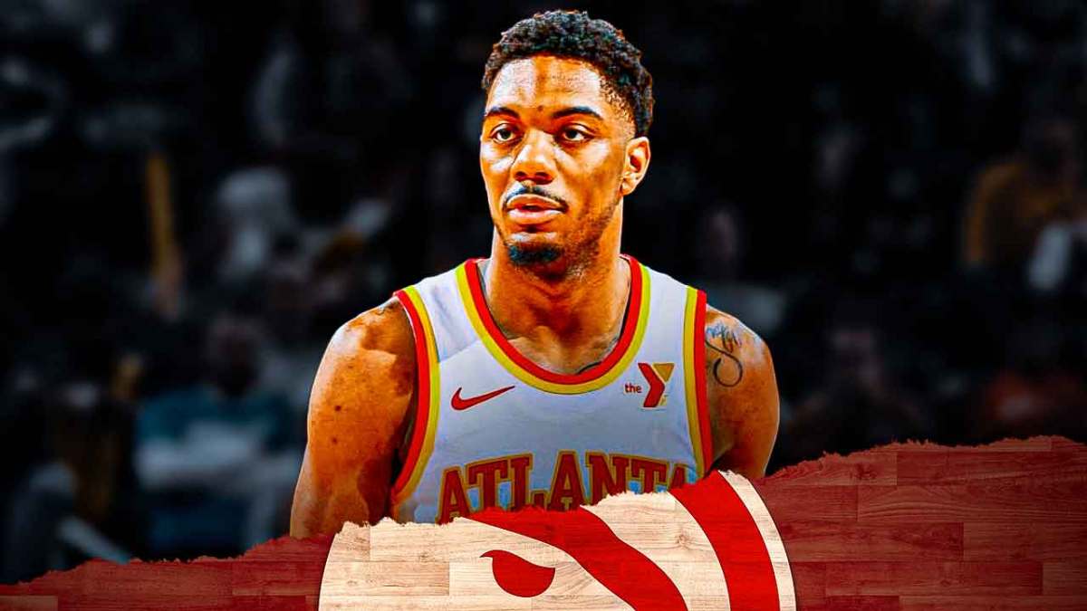 Trent Forrest in an Atlanta Hawks jersey with the Hawks arena in the background