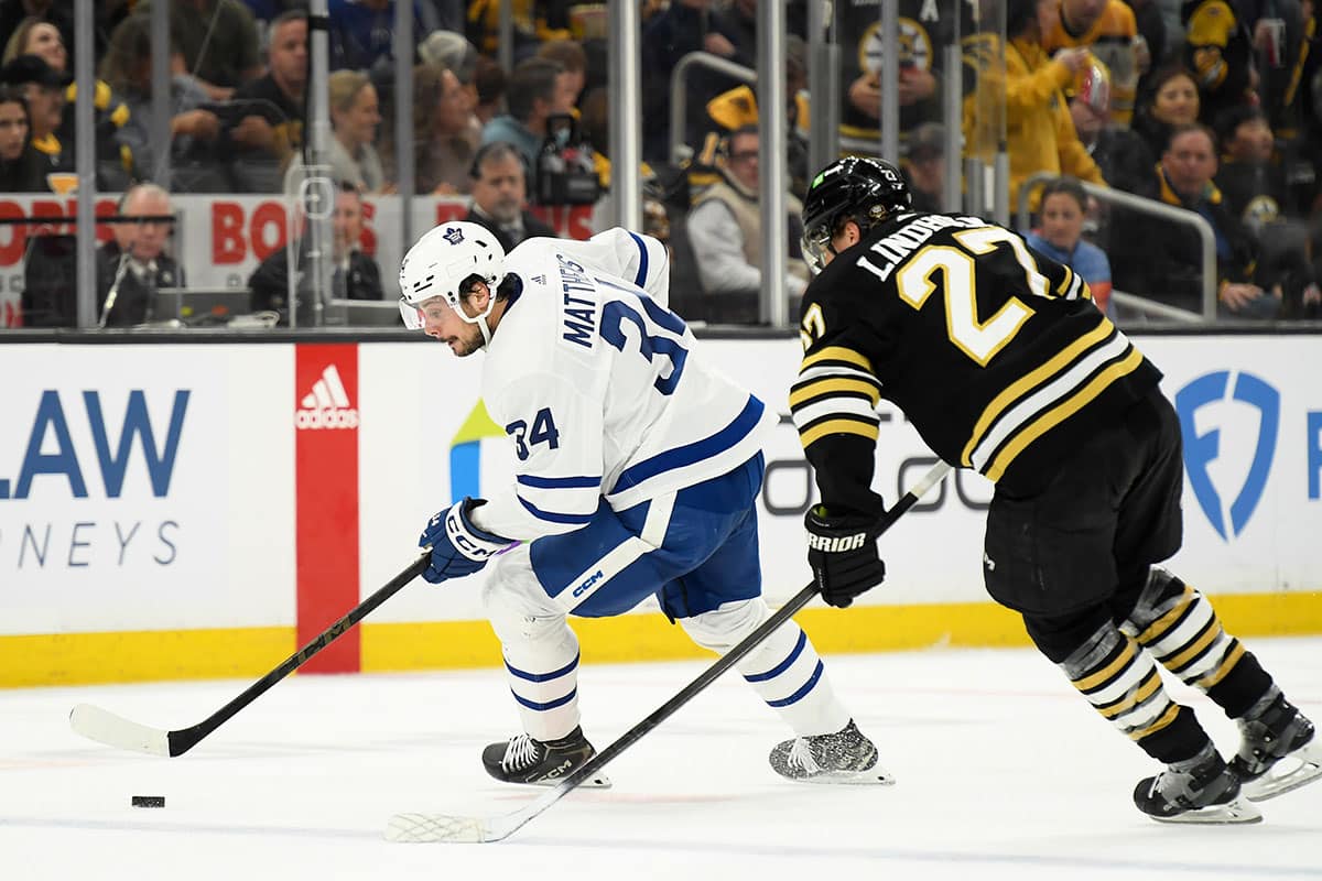 Toronto Maple Leafs center Auston Matthews (34) controls the puck while Boston Bruins defenseman Hampus Lindholm (27) defends during the second period in game one of the first round of the 2024 Stanley Cup Playoffs at TD Garden.