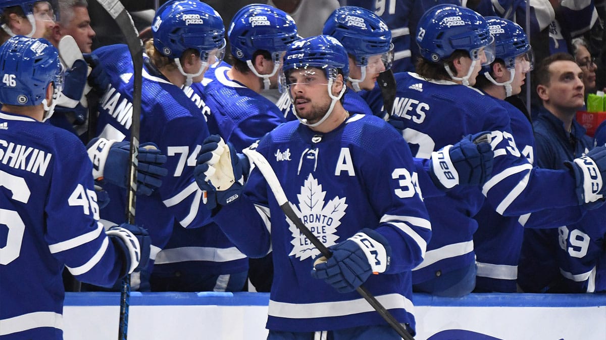 Toronto Maple Leafs forward Auston Matthews (34) celebrates with team mates at the bench after scoring a goal against the New Jersey Devils in the second period at Scotiabank Arena. 