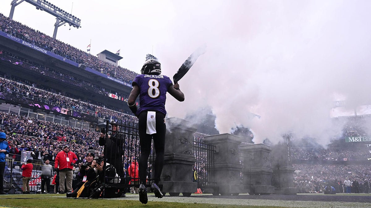 Baltimore Ravens quarterback Lamar Jackson (8) runs onto the field during player introductions prior to the AFC Championship football game against the Kansas City Chiefs at M&T Bank Stadium.