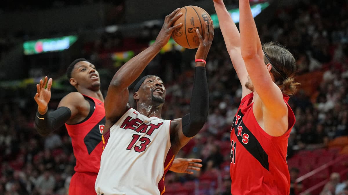 Miami Heat center Bam Adebayo (13) goes up for a shot as Toronto Raptors forward Kelly Olynyk (41) defends during the first half at Kaseya Center. 
