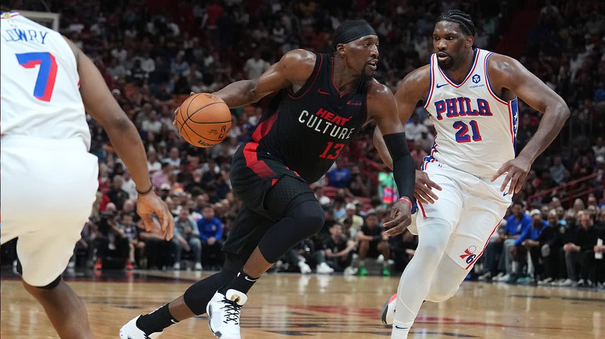 Miami Heat center Bam Adebayo (13) drives to the basket as Philadelphia 76ers center Joel Embiid (21) defends during the first half at Kaseya Center.