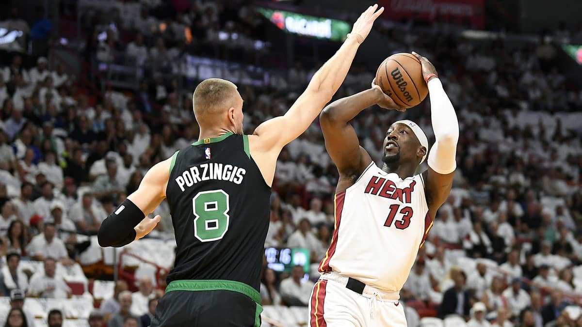 Miami Heat center Bam Adebayo (13) shoots over Boston Celtics center Kristaps Porzingis (8) during the first quarter of game four of the first round for the 2024 NBA playoffs at Kaseya Center. 