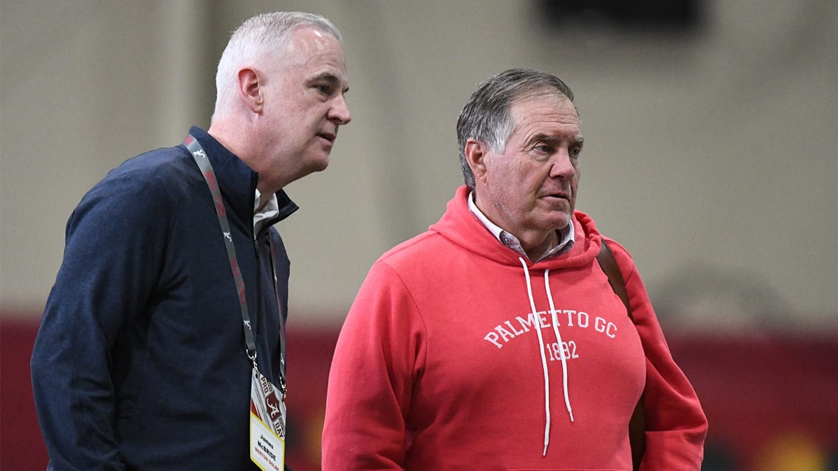 New England Patriots head coach Bill Belichick talks with Boston Globe writer James McBride as they view the University of Alabama s Pro Day at Hank Crisp Indoor Facility.