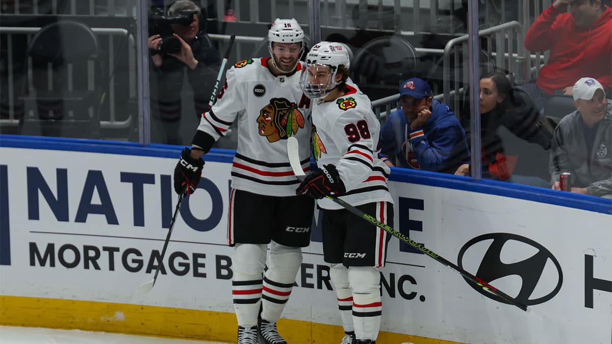 Chicago Blackhawks center Jason Dickinson (16) celebrates his goal with Chicago Blackhawks center Connor Bedard (98) against the New York Islanders during the first period at UBS Arena.