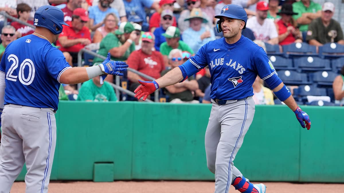 Toronto Blue Jays infielder Joey Votto (37) is congratulated after hitting a home run against the Philadelphia Phillies during the first inning at BayCare Ballpark