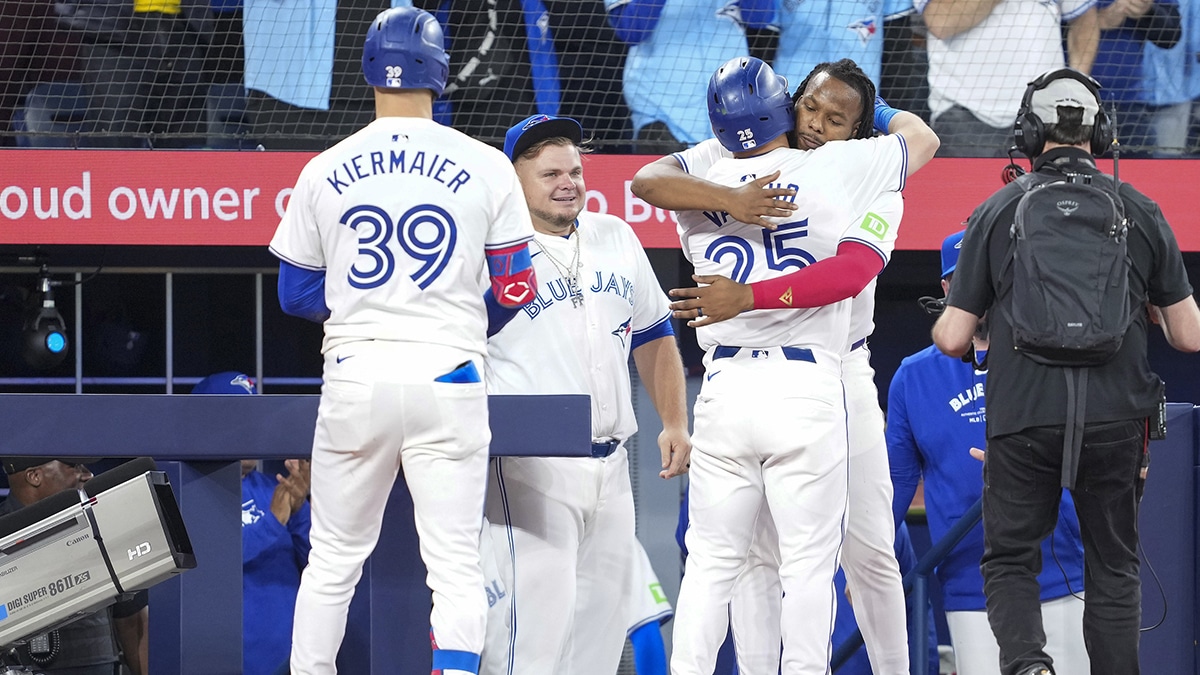 Toronto Blue Jays left fielder Daulton Varsho (25) hits a home run and celebrates with first base Vladimir Guerrero Jr. (27) against the New York Yankees during the seventh inning at Rogers Centre.
