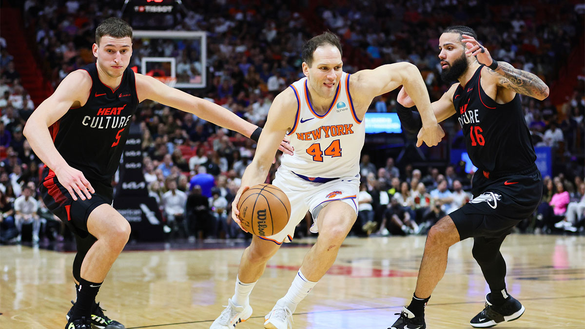 New York Knicks forward Bojan Bogdanovic (44) drives to the basket past Miami Heat forward Nikola Jovic (5) and forward Caleb Martin (16) during the first quarter at Kaseya Center.