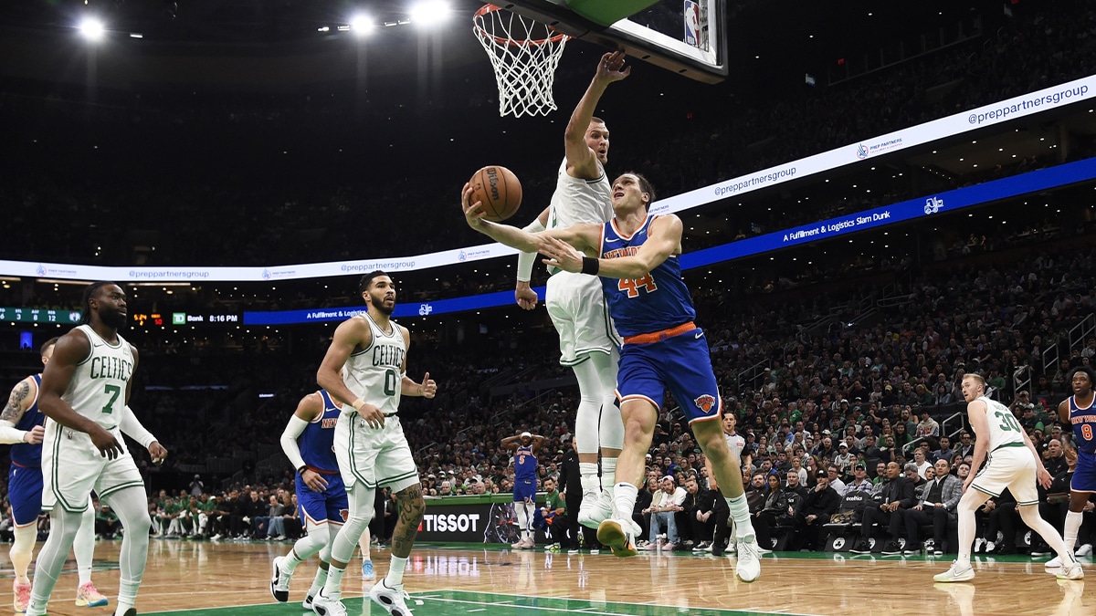 New York Knicks forward Bojan Bogdanovic (44) drives to the basket past Boston Celtics center Kristaps Porzingis (8) during the first half at TD Garden. 