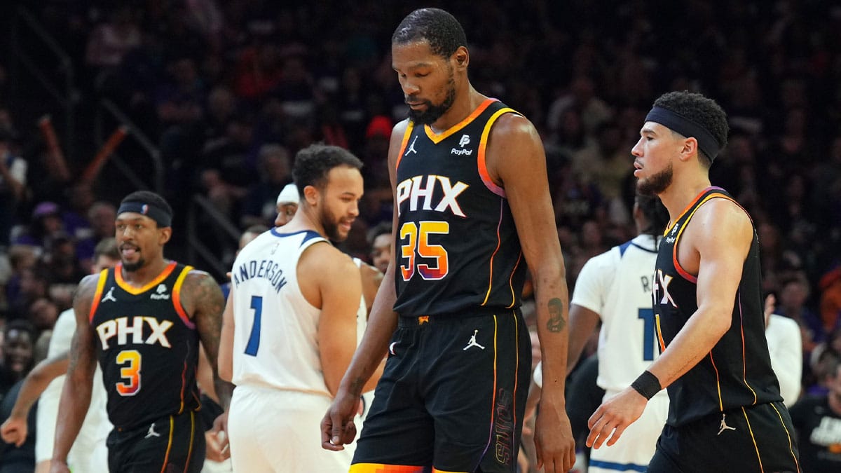 Phoenix Suns guard Bradley Beal (3) and Phoenix Suns forward Kevin Durant (35) and Phoenix Suns guard Devin Booker (1) react while Minnesota Timberwolves celebrate during the second half of game three of the first round for the 2024 NBA playoffs at Footprint Center.