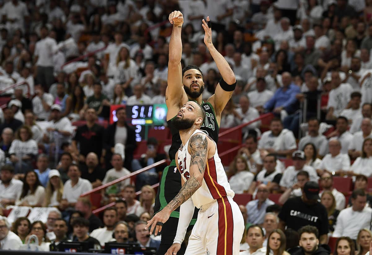 Boston Celtics forward Jayson Tatum (0) takes a 3-point shot in front of Miami Heat forward Caleb Martin (16) during the second quarter of game four of the first round for the 2024 NBA playoffs at Kaseya Center. 