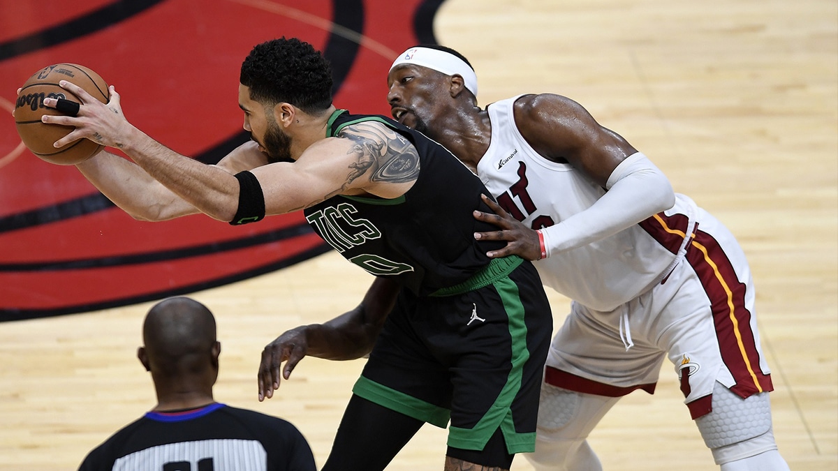 Apr 29, 2024; Miami, Florida, USA; Boston Celtics forward Jayson Tatum (0) keeps the ball away from Miami Heat center Bam Adebayo (13) during the fourth quarter of game four of the first round for the 2024 NBA playoffs at Kaseya Center. Mandatory Credit: Michael Laughlin-USA TODAY Sports
