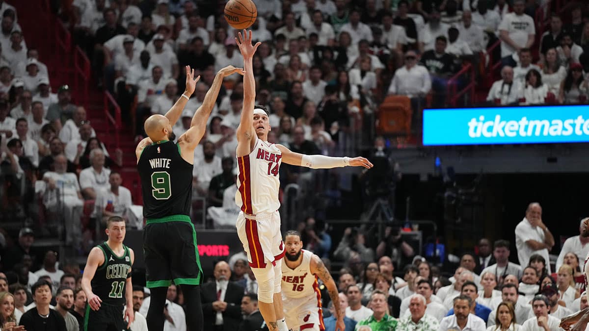 Apr 27, 2024; Miami, Florida, USA; Boston Celtics guard Derrick White (9) shoots over Miami Heat guard Tyler Herro (14) in the first half during game three of the first round for the 2024 NBA playoffs at Kaseya Center. Mandatory Credit: Jim Rassol-USA TODAY Sports