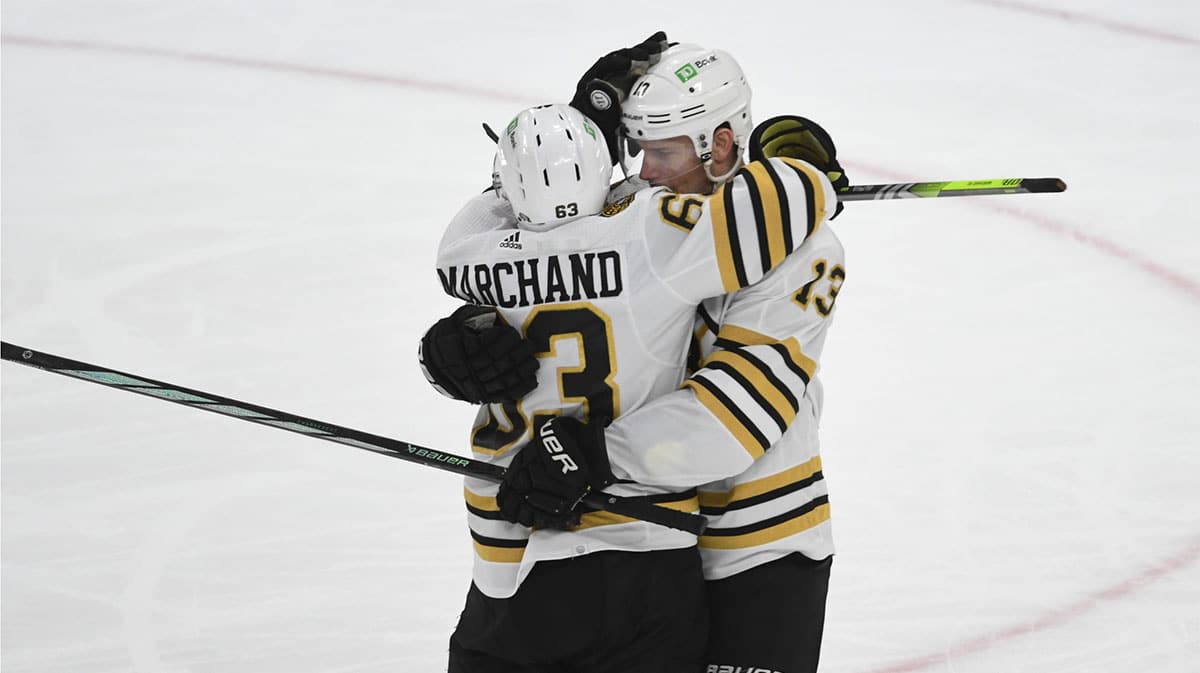 Boston Bruins left wing Brad Marchand (63) celebrates a goal with center Charlie Coyne (13)against the Pittsburgh Penguins during the second period at PPG Paints Arena
