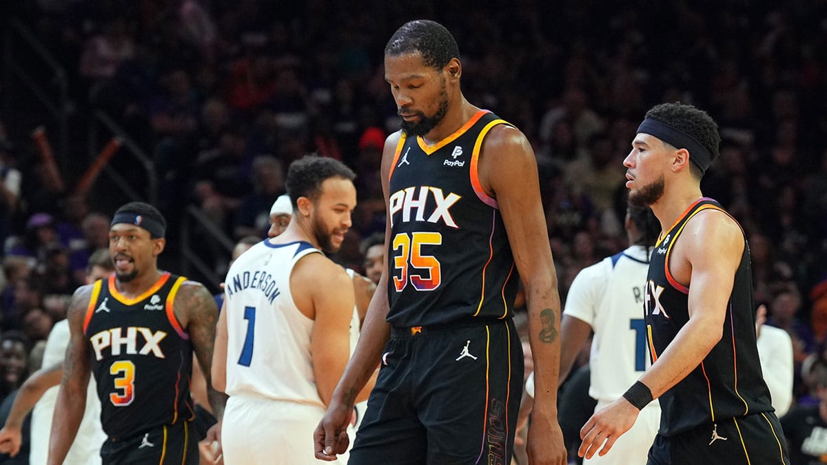 Phoenix Suns guard Bradley Beal (3) and Phoenix Suns forward Kevin Durant (35) and Phoenix Suns guard Devin Booker (1) react while Minnesota Timberwolves celebrate during the second half of game three of the first round for the 2024 NBA playoffs at Footprint Center
