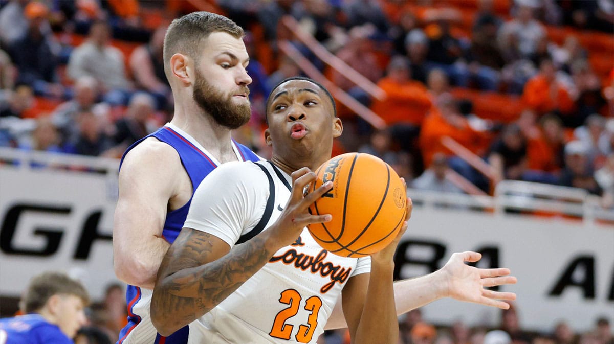 Oklahoma State Cowboys center Brandon Garrison (23) tries to get past Kansas Jayhawks center Hunter Dickinson (1) during a college basketball game between the Oklahoma State University Cowboys (OSU) and the Kansas Jayhawks at Gallagher-Iba Arena in Stillwater, Okla., Tuesday, Jan. 16, 2024.