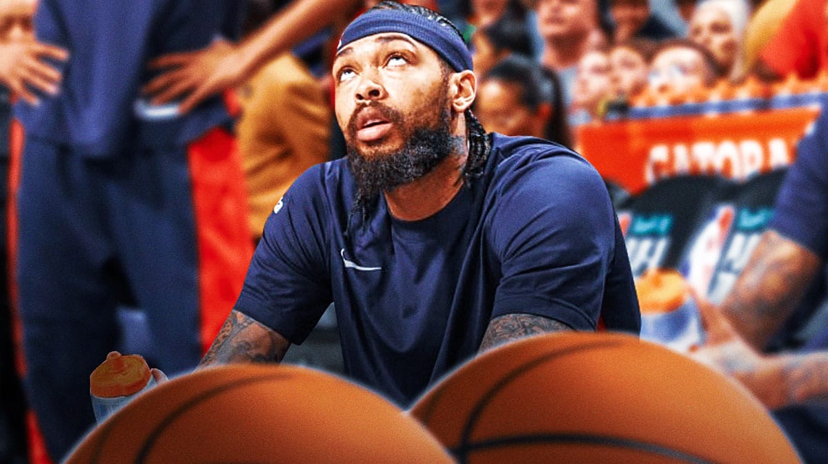 Pelicans' Brandon Ingram sitting down on an NBA sideline looking upset.