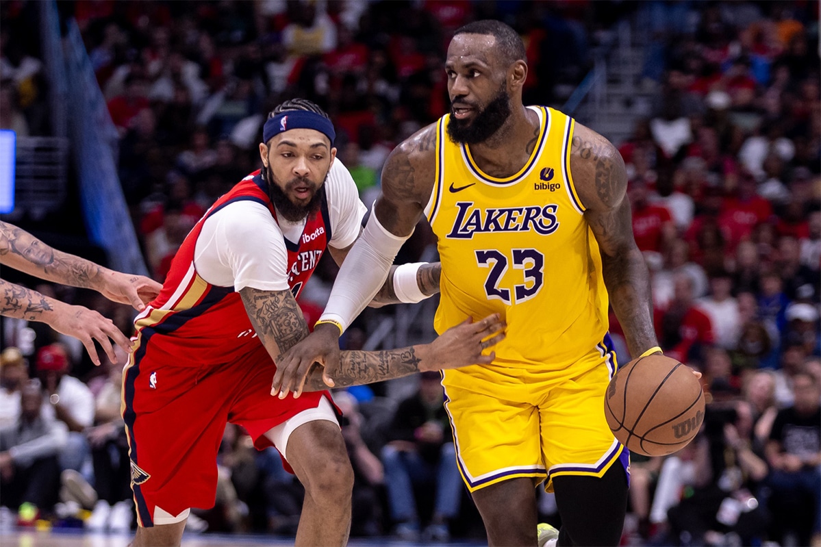Los Angeles Lakers forward LeBron James (23) dribbles against New Orleans Pelicans forward Brandon Ingram (14) during the second half of a play-in game of the 2024 NBA playoffs at Smoothie King Center