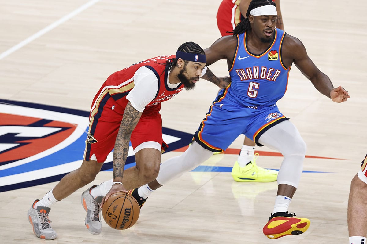 New Orleans Pelicans forward Brandon Ingram (14) drives to the basket beside Oklahoma City Thunder guard Luguentz Dort (5) during the first quarter during game two of the first round for the 2024 NBA playoffs at Paycom Center.