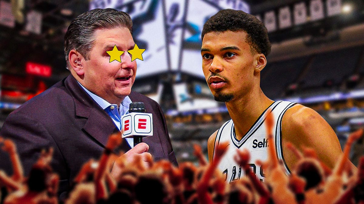 Brian Windhorst on one side with stars in his eyes, Victor Wembanyama on the other side