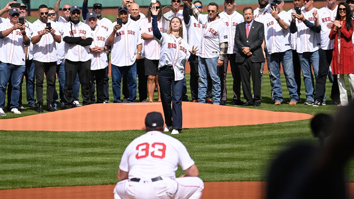 Brianna Wakefield, daughter of former pitcher Tim Wakefield throws the first pitch to game planning coordinator/catching coach Jason Varitek (33) during opening day ceremonies as seen before a game between the Boston Red Sox and the Baltimore Orioles at Fenway Park.