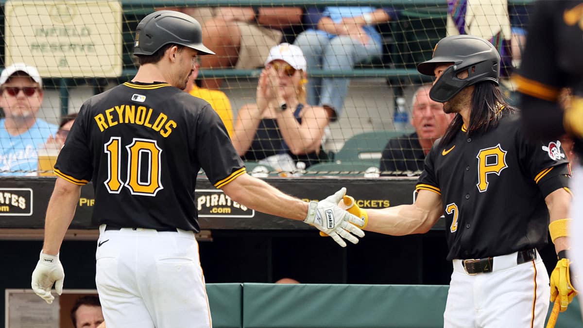 Mar 1, 2024; Bradenton, Florida, USA; Pittsburgh Pirates left fielder Bryan Reynolds (10) is congratulated by right fielder Connor Joe (2) after he hit a home run during the first inning at LECOM Park. 
