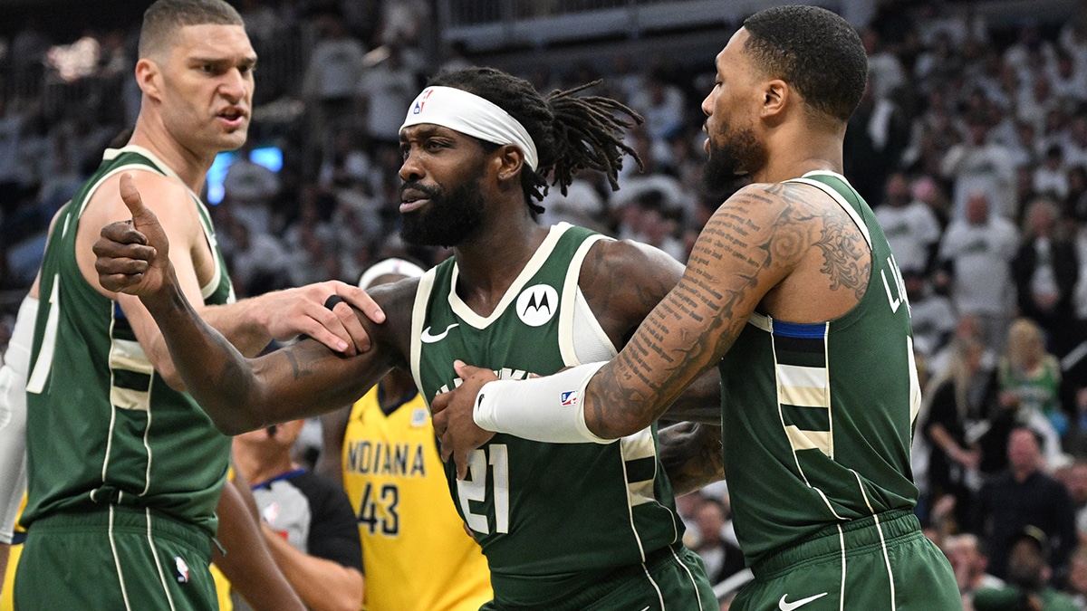 Milwaukee Bucks guard Patrick Beverley (21) is held back by guard Damian Lillard (0) during a rebound against the Indiana Pacers in the second half during game two of the first round for the 2024 NBA playoffs at Fiserv Forum.